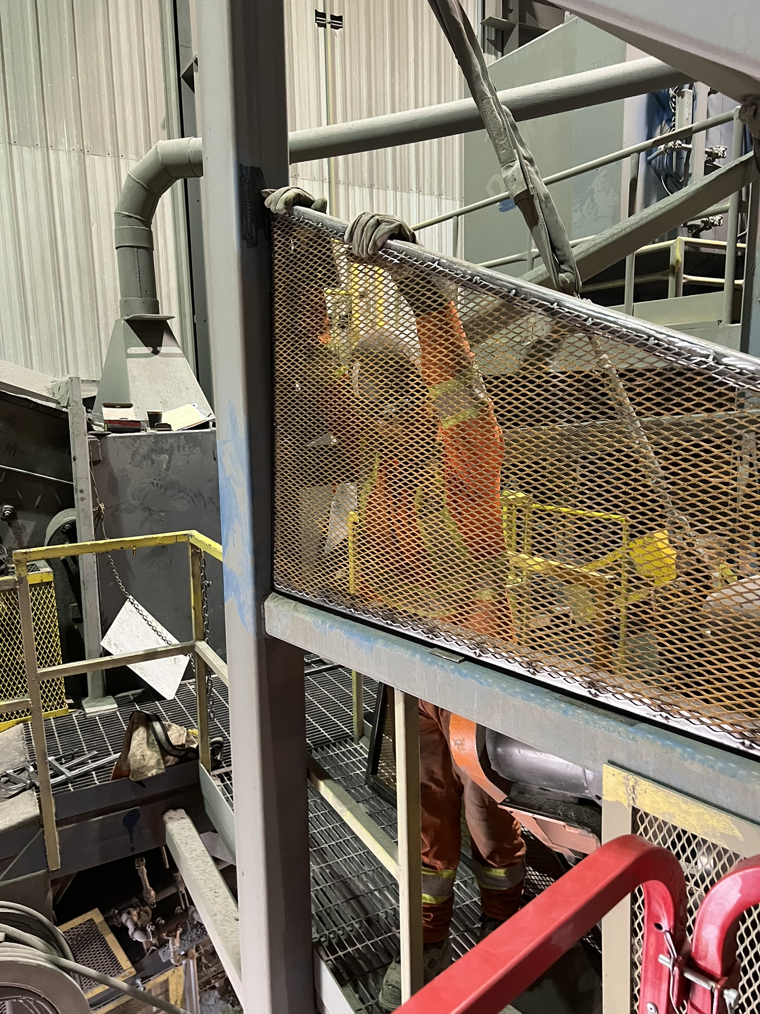JTR worker behind safety mesh during industrial maintenance work